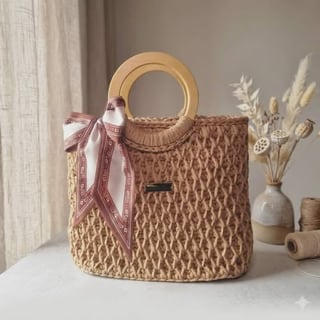 Woven straw handbag with wooden handles and pink ribbon bow