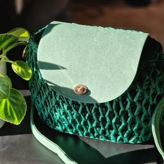 Green quilted crossbody bag with cream flap and gold button clasp