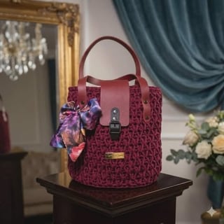 Deep red textured handbag with handles and silk scarf
