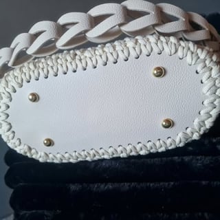 White leather clutch with braided trim and gold studs