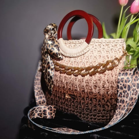Woven beige and brown ombré handbag with red handles, leopard print accents, and pink tulips