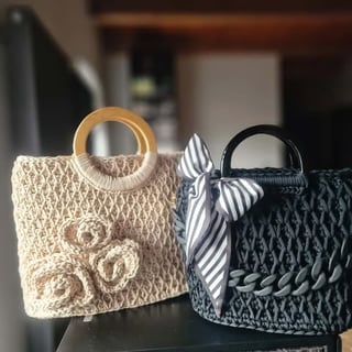 Two woven handbags side by side: cream-colored and black textured bag