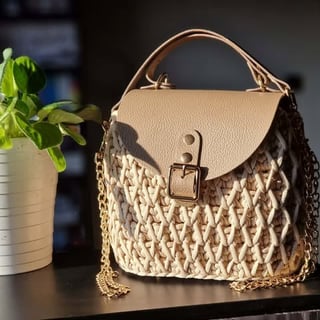 Beige woven handbag with leather flap top and gold chain strap
